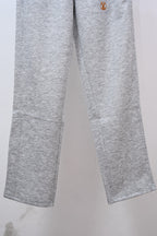 Gray sweatpants legs with small Louis Vuitton emblem