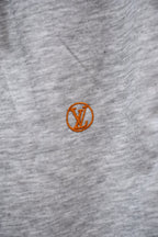 Gray sweatpants with small orange Louis Vuitton emblem
