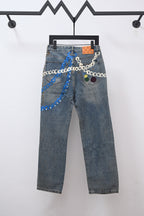 Denim pants with multicolor chain trim and patchwork graphics across the front
