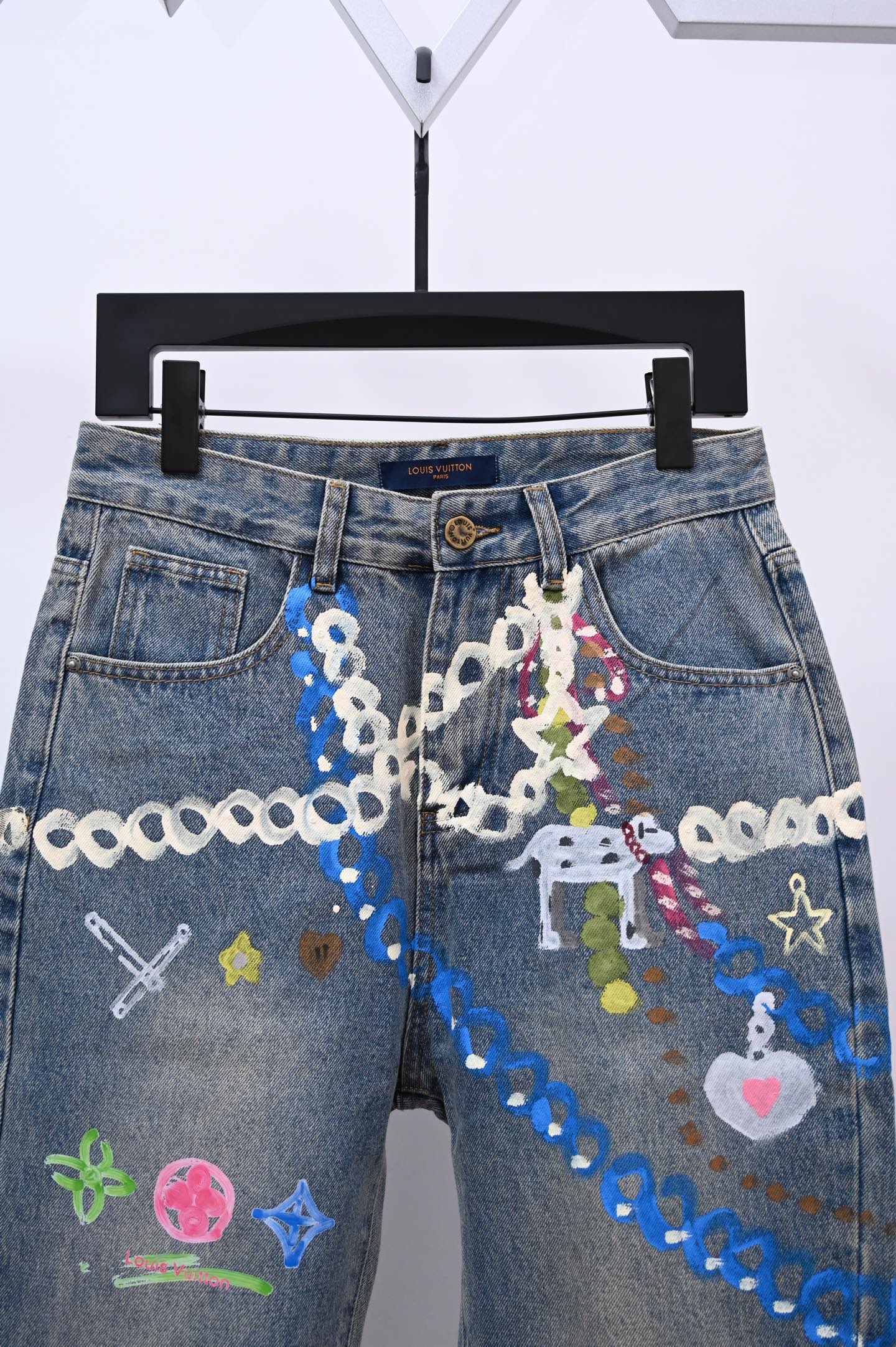 Denim pants with dense multicolor applique and chain detail on front