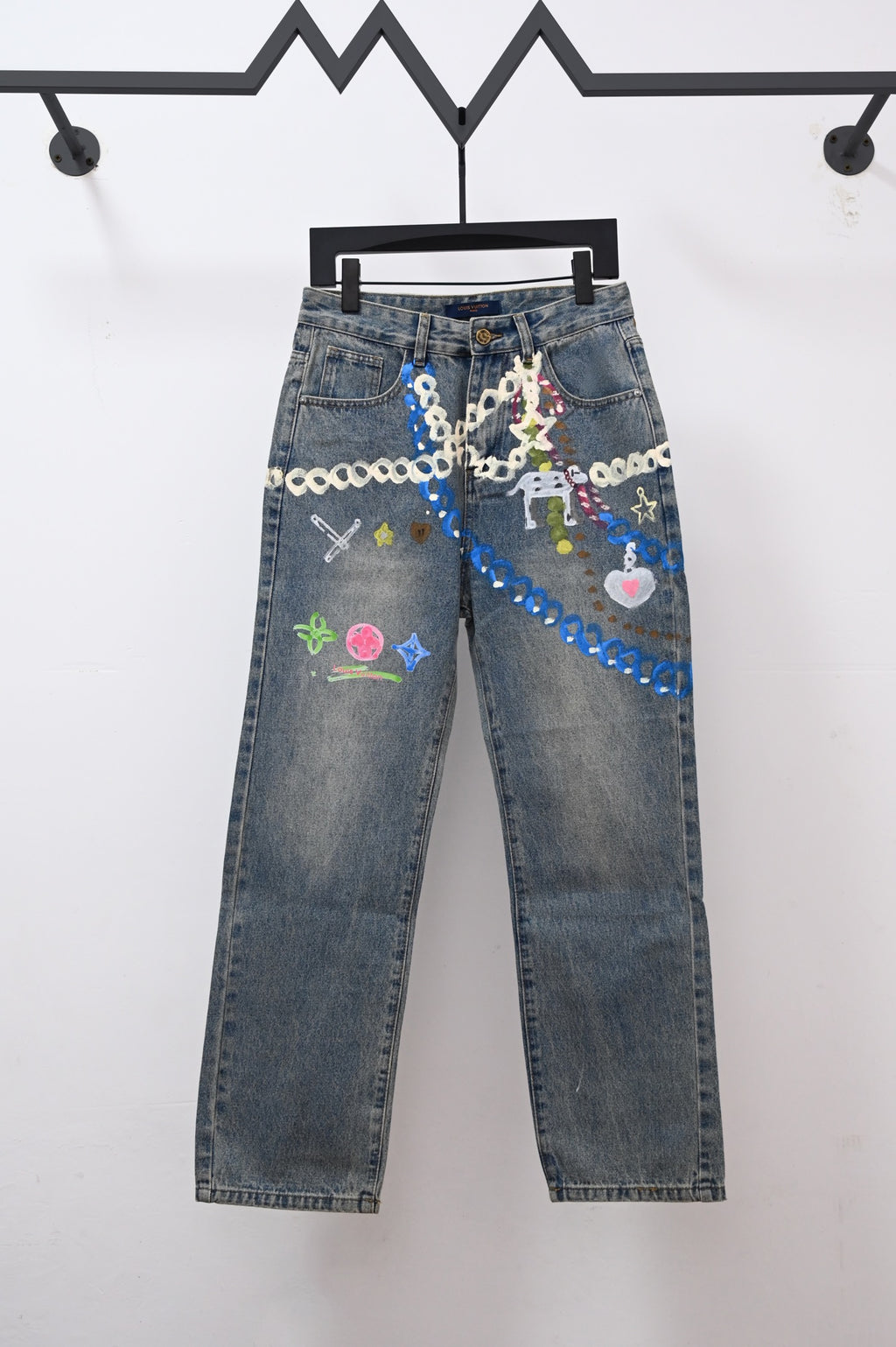 Denim pants with colorful chain and charm-style graphic embroidery on front pockets