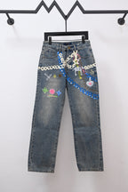 Denim pants with colorful chain and charm-style graphic embroidery on front pockets