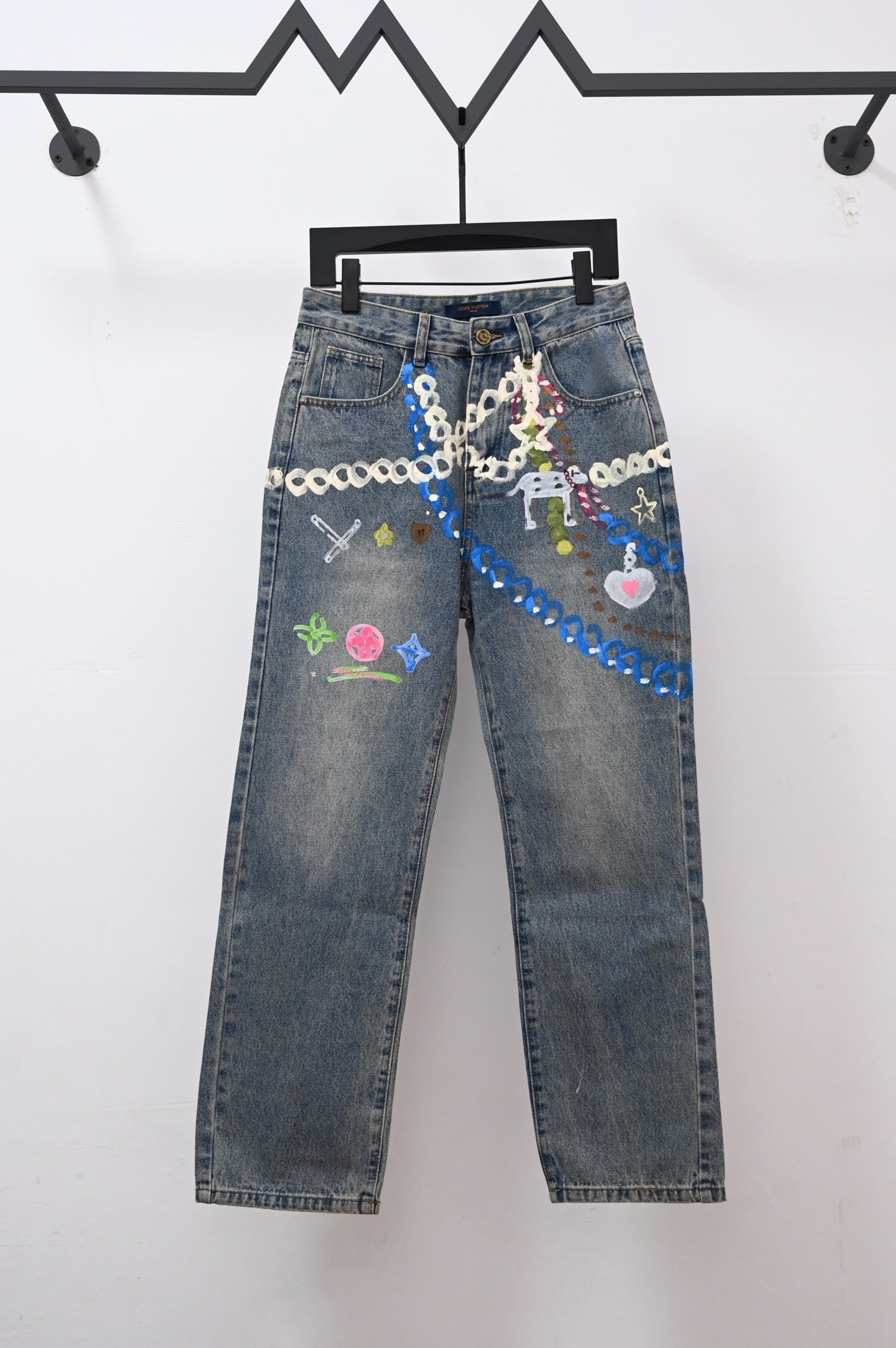 Denim pants with colorful chain and charm-style graphic embroidery on front pockets