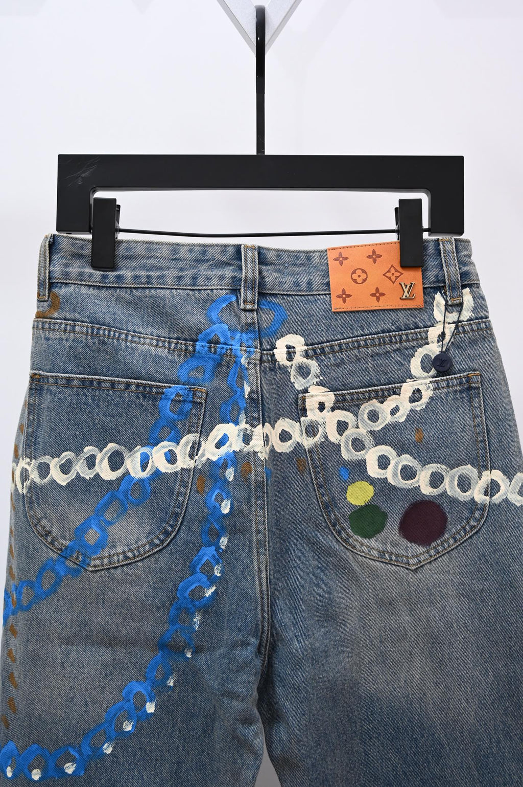 Denim pants with chain trim and multicolor applique on both front pockets