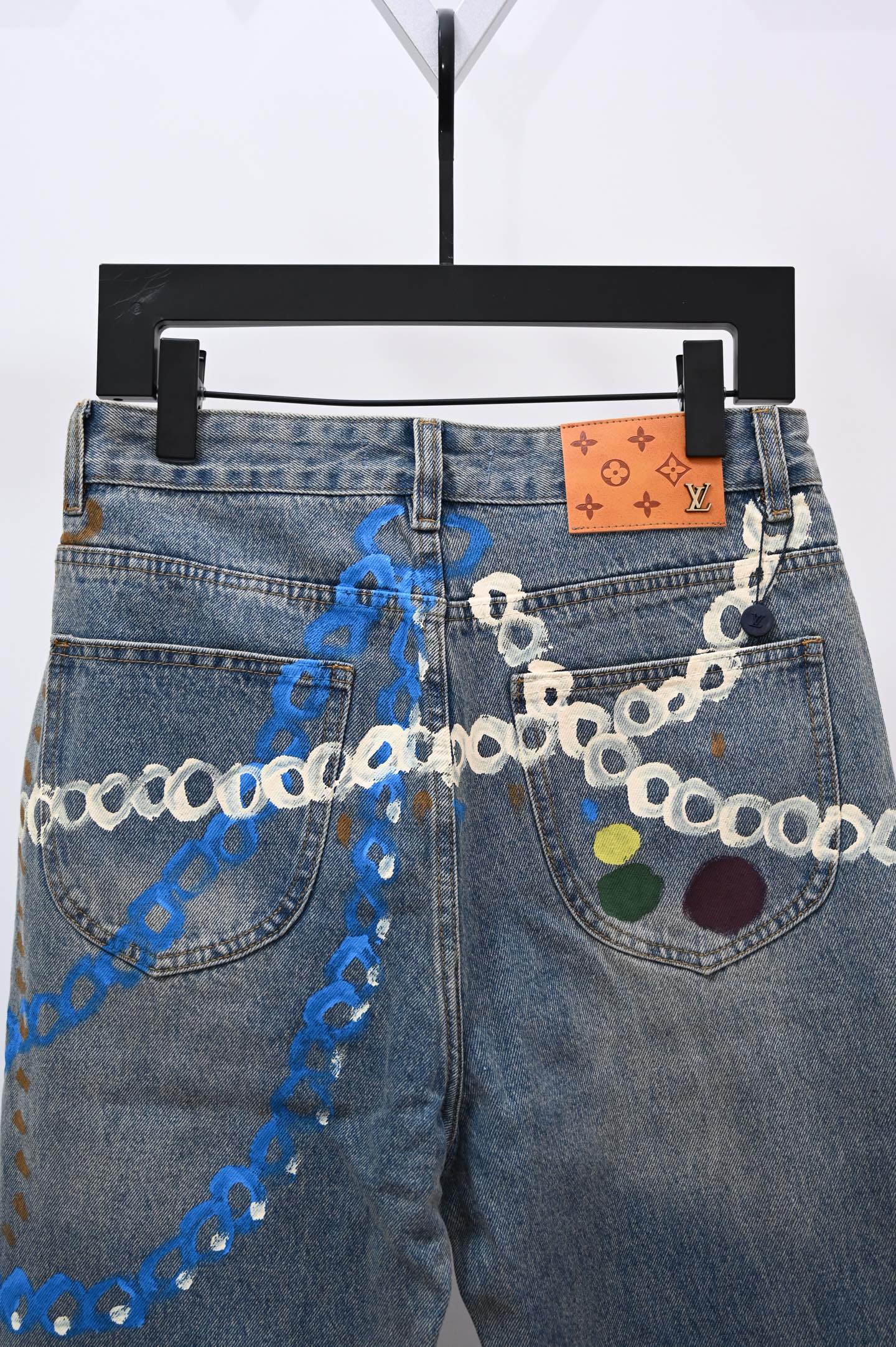 Denim pants with chain trim and multicolor applique on both front pockets