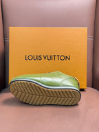 Green sneaker outsole view with textured tread and yellow-edged midsole