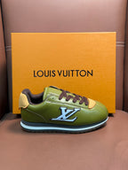 Green leather sneaker with dark brown laces, blue LV logo, and light sole