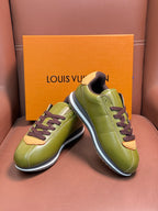 Pair of green leather sneakers with dark brown laces and white midsole