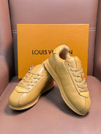 Louis Vuitton luxury sneakers in light tan, angled front and side