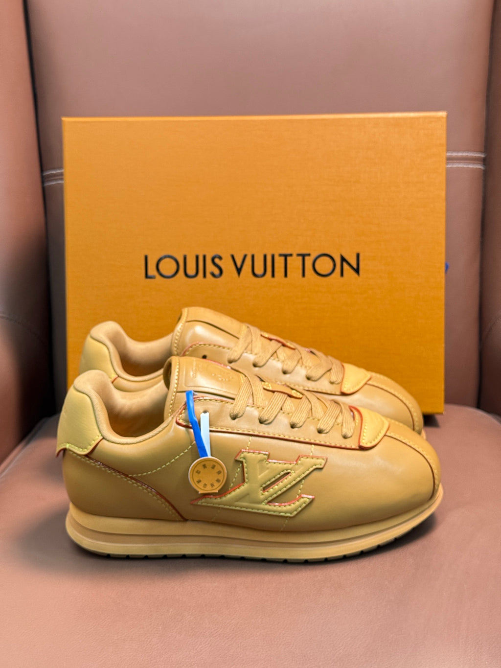 Louis Vuitton luxury low-top sneakers in light tan with lace-up design