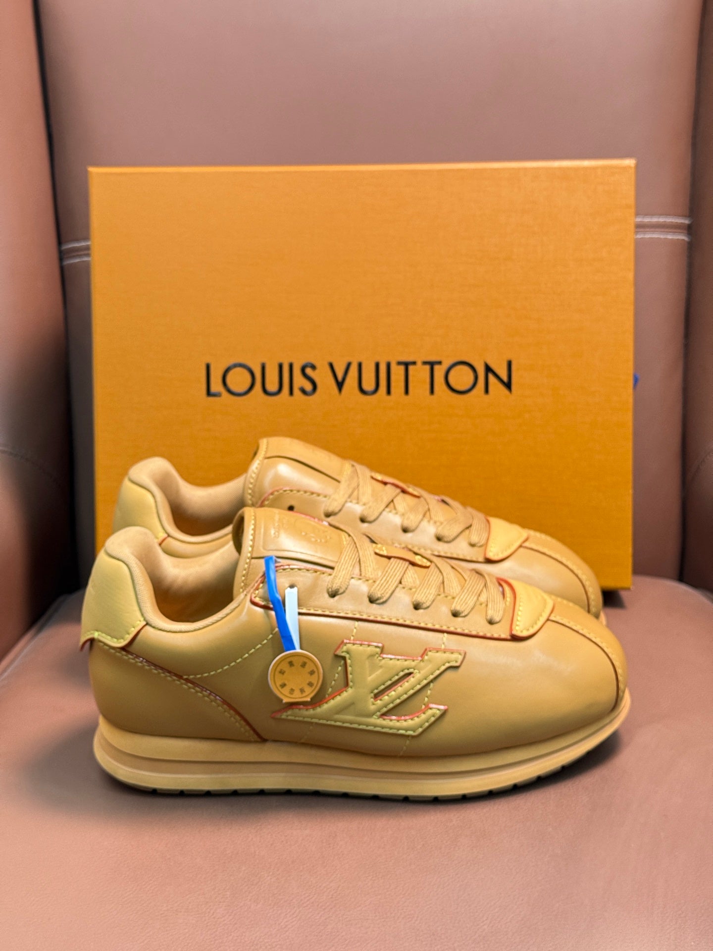 Louis Vuitton luxury low-top sneakers in light tan with lace-up design