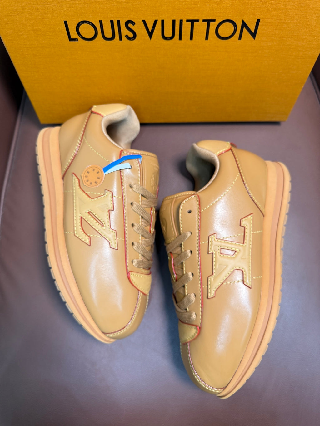 Louis Vuitton luxury sneakers, light tan, showing front and side details
