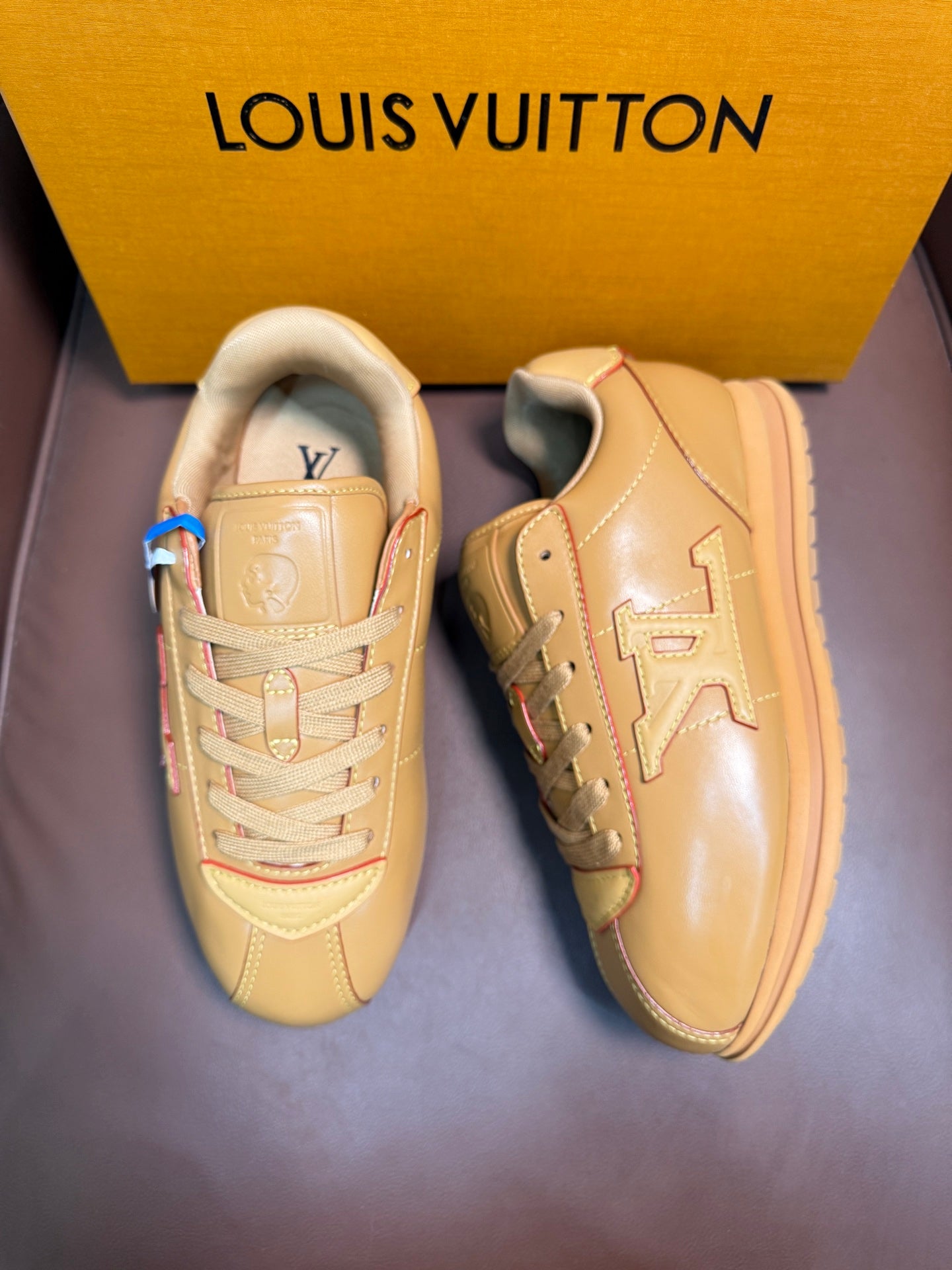 Louis Vuitton luxury sneakers, light tan, shown side and quarter views
