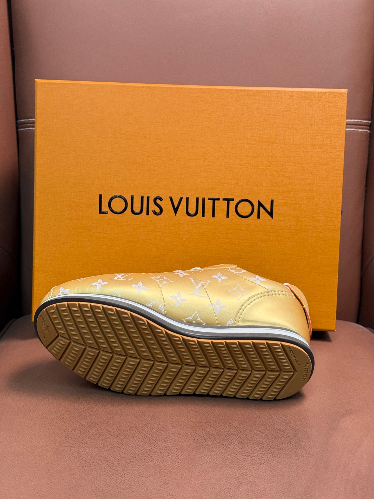 Gold monogram sneaker outsole with blue sole edge and textured tread