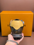 Louis Vuitton monogram sneaker heel view with yellow trim and dark rubber sole