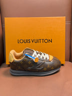 Louis Vuitton monogram sneakers with white laces, tan lining, and blue trim detail