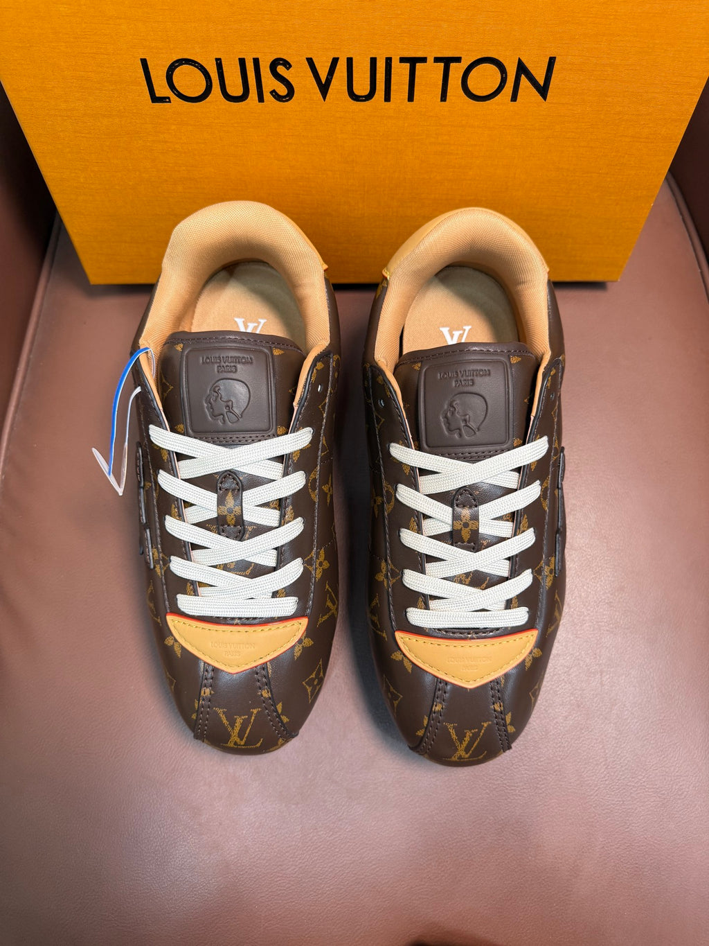 Louis Vuitton monogram sneakers with white laces and tan lining, dark brown finish