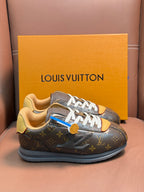 Louis Vuitton monogram sneakers on yellow box, white laces and tan interior lining