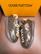 Louis Vuitton monogram sneakers with white laces and tan accents, side view