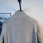 Light blue knit zip-up sweater with ribbed turtleneck collar on a mannequin