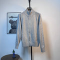 Light blue knit zip-up sweater with ribbed collar and cuffs on a mannequin