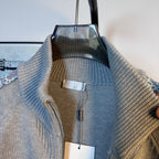 Light blue knit zip-up sweater lining and inner label visible through collar opening