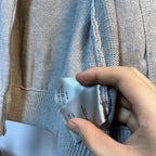 Light blue knit sweater with inner neck label and zipper pull detail