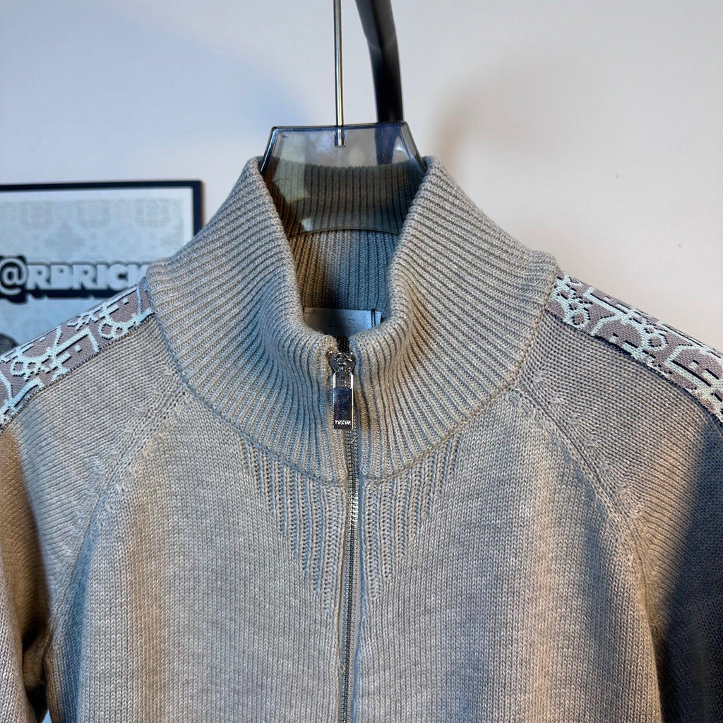 Light blue knit zip-up sweater with ribbed stand collar and patterned side trim