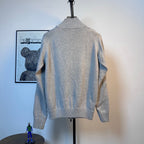 Light blue knit zip-up sweater, back view, ribbed hem and neckline details