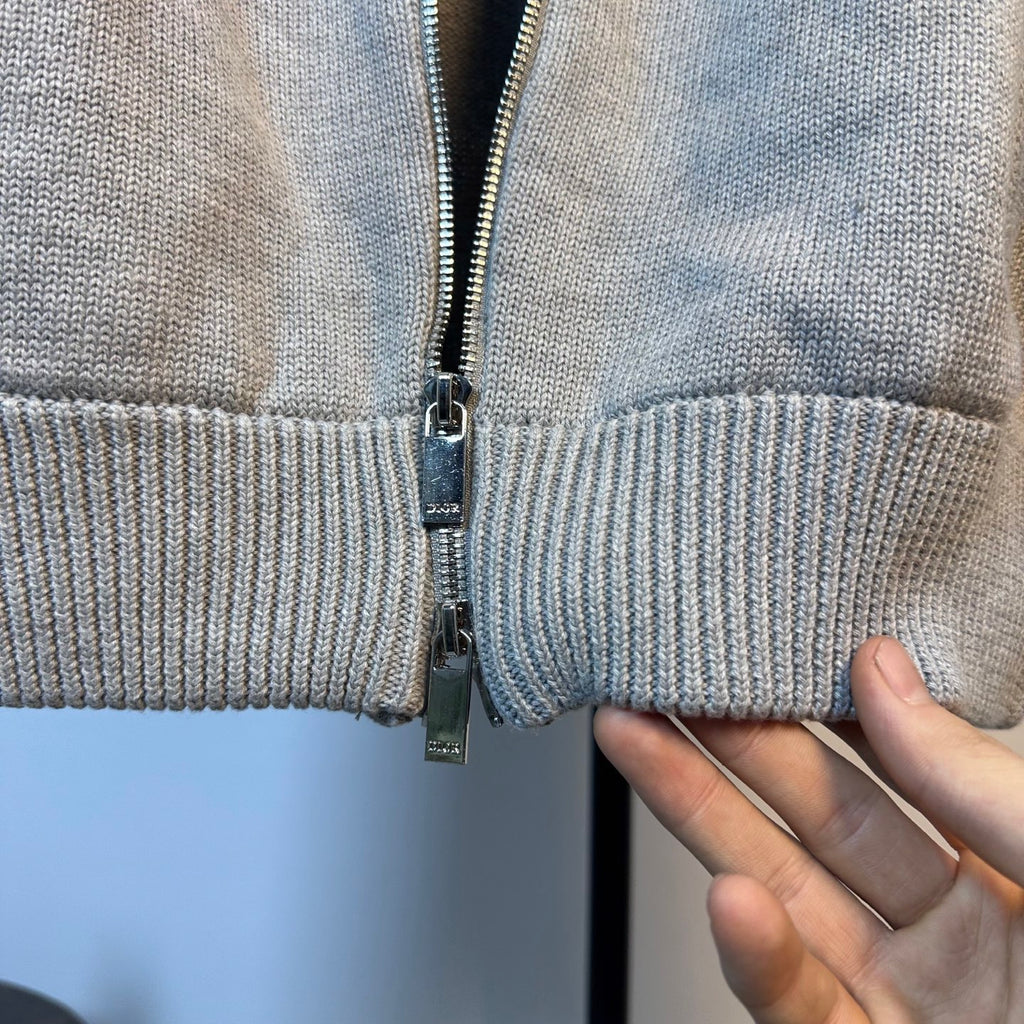 Light blue knit sweater with center front zipper and ribbed waistband band