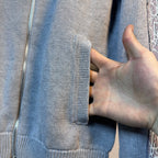 Light blue knit sweater fabric detail with front zip track and pocket panel