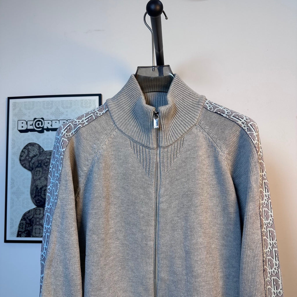 Light blue knit zip-up sweater with stand collar and front zipper on a mannequin