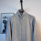 Light blue knit zip-up sweater with stand collar and front zipper on a mannequin