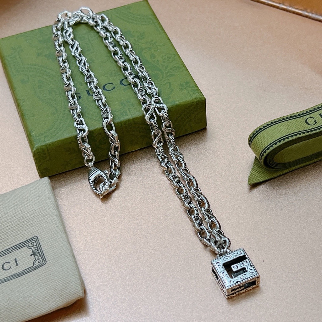 Silver chain necklace with square black enamel pendant on link chain