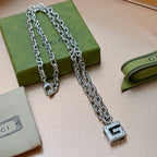 Silver chain necklace with square black enamel pendant on link chain