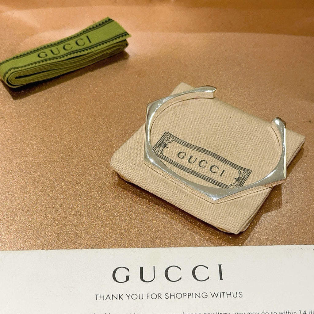 Gucci silver bangle in beige pouch with Gucci logo label