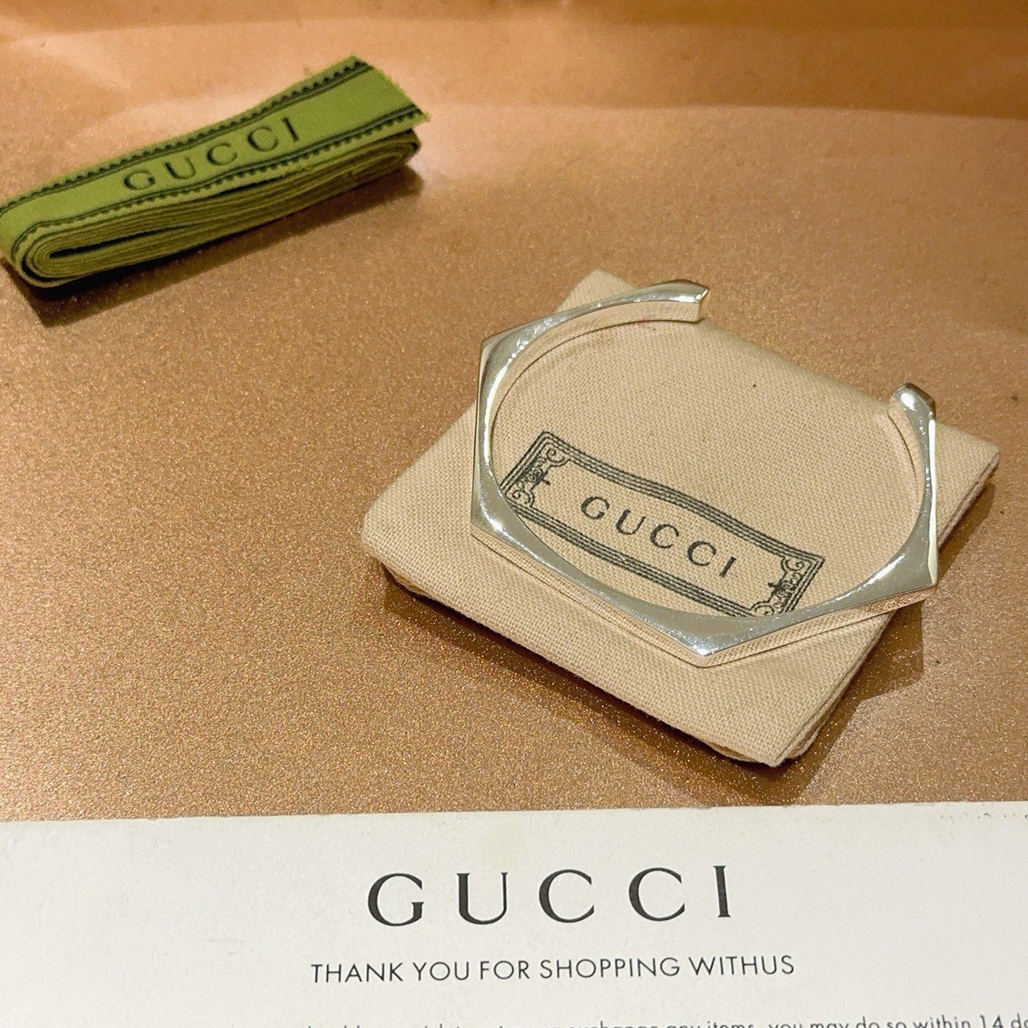 Gucci silver bangle in beige pouch with Gucci logo label