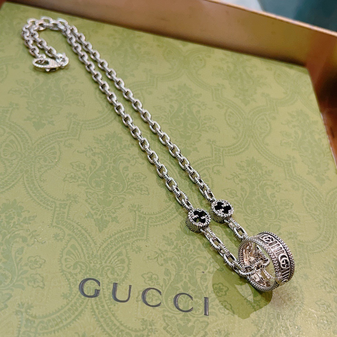 Silver-tone chain necklace with black enamel oval pendants and Gucci logo engraving