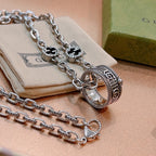 Silver-tone chain necklace with double oval pendant and black enamel insets