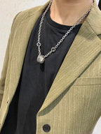 Silver-tone chain necklace with small oval logo charm pendant