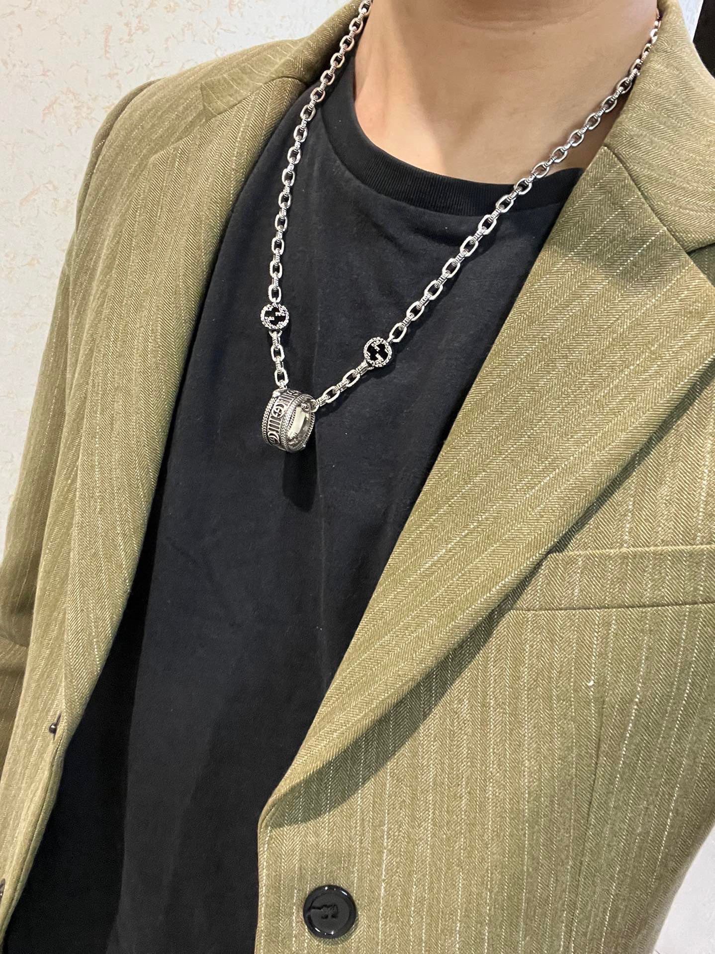 Silver-tone chain necklace with small oval logo charm pendant