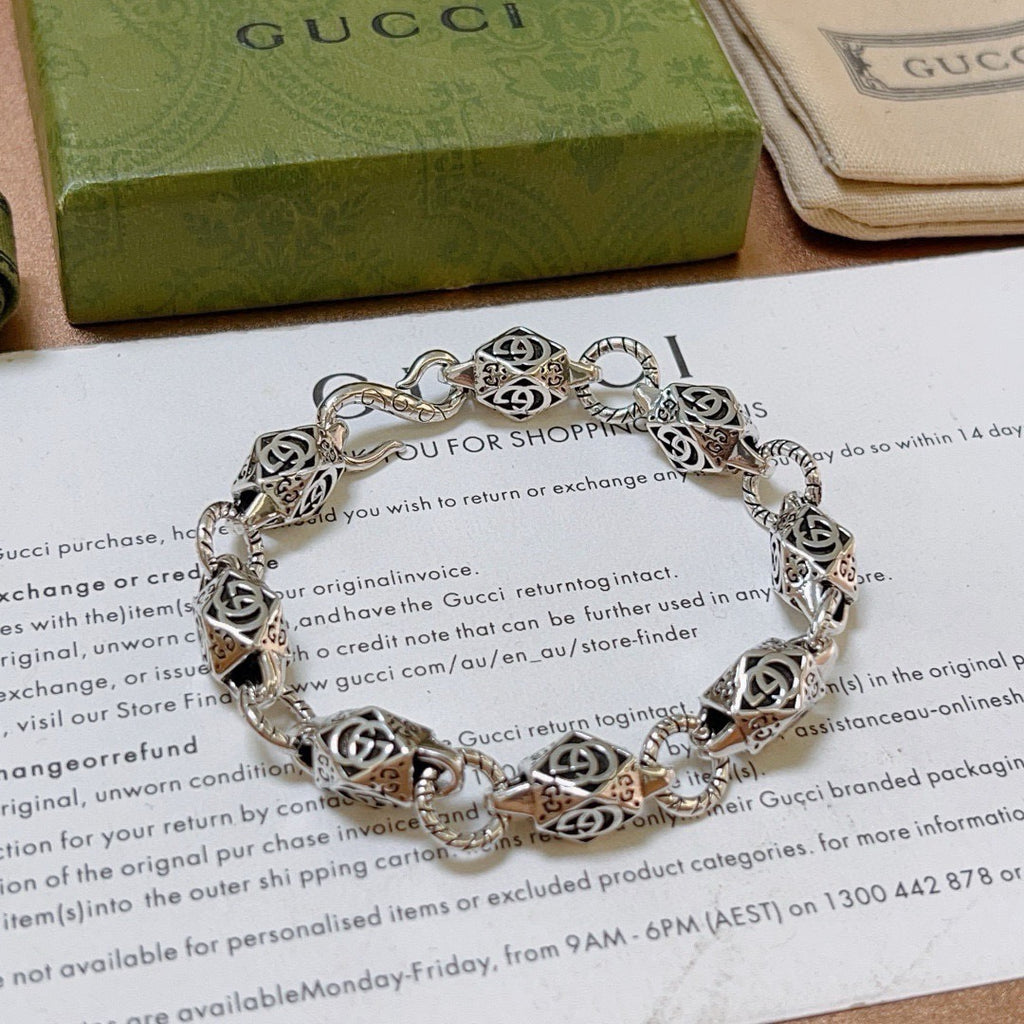 Silver logo-link bracelet with detailed charm links