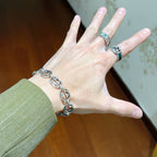 Silver-tone chunky link bracelet on wrist with interlocking oval chain links