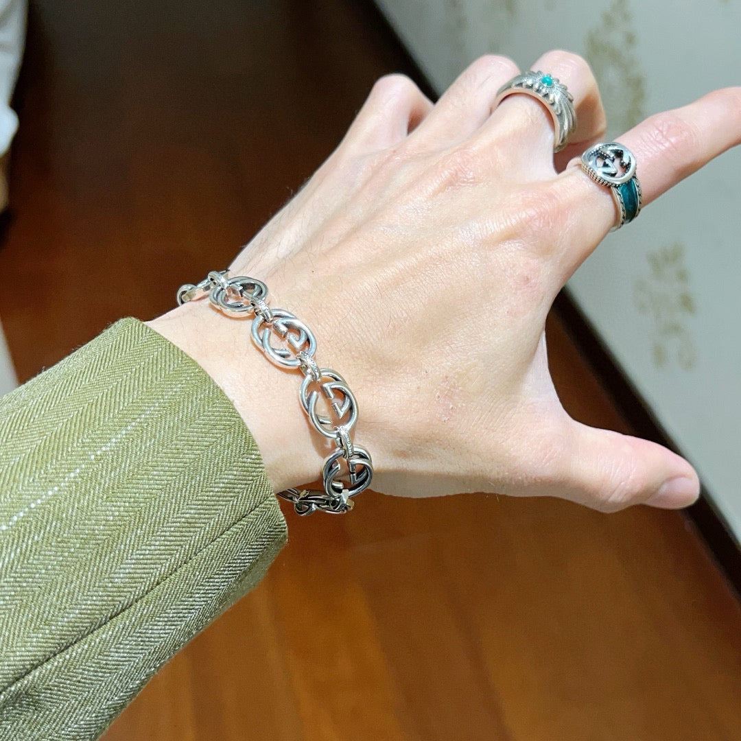 Silver-tone chunky chain bracelet on wrist with oval links
