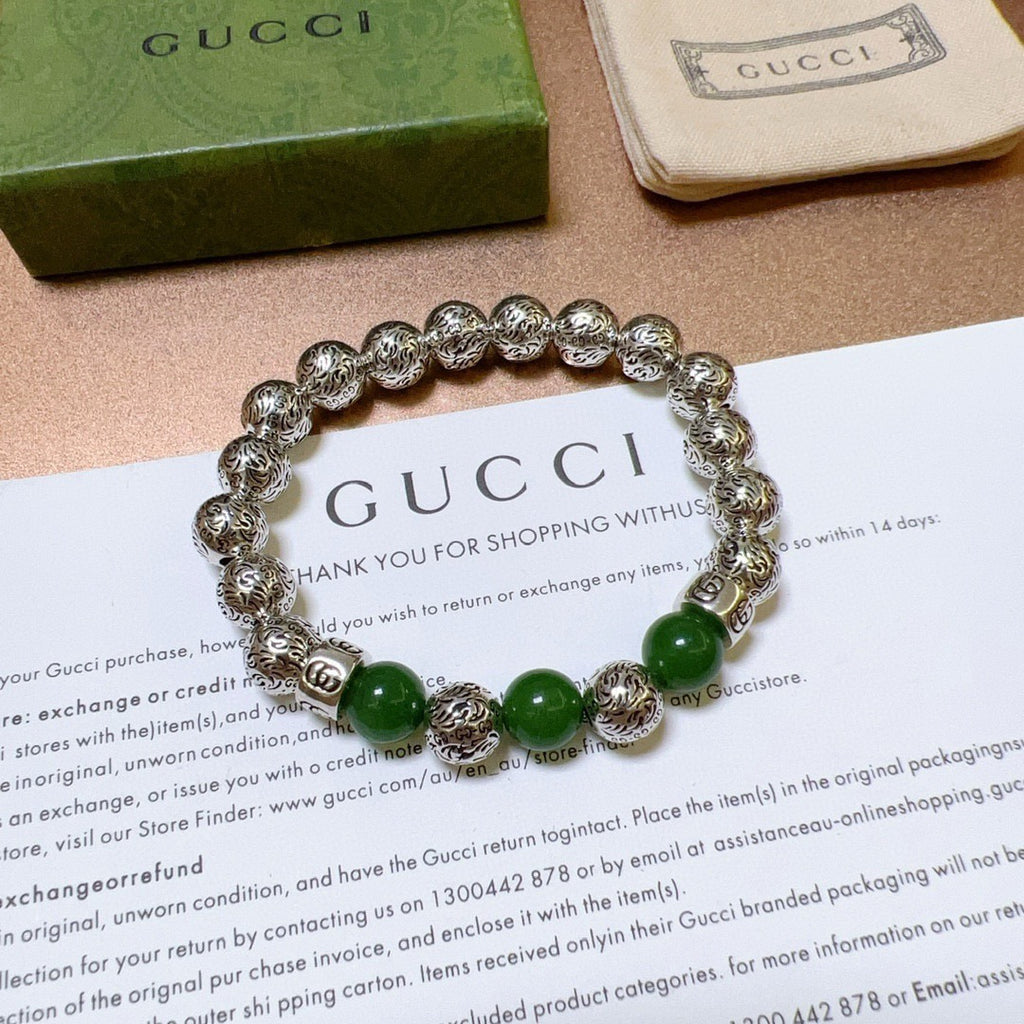 Silver beaded bracelet with green beads shown on a thank-you card