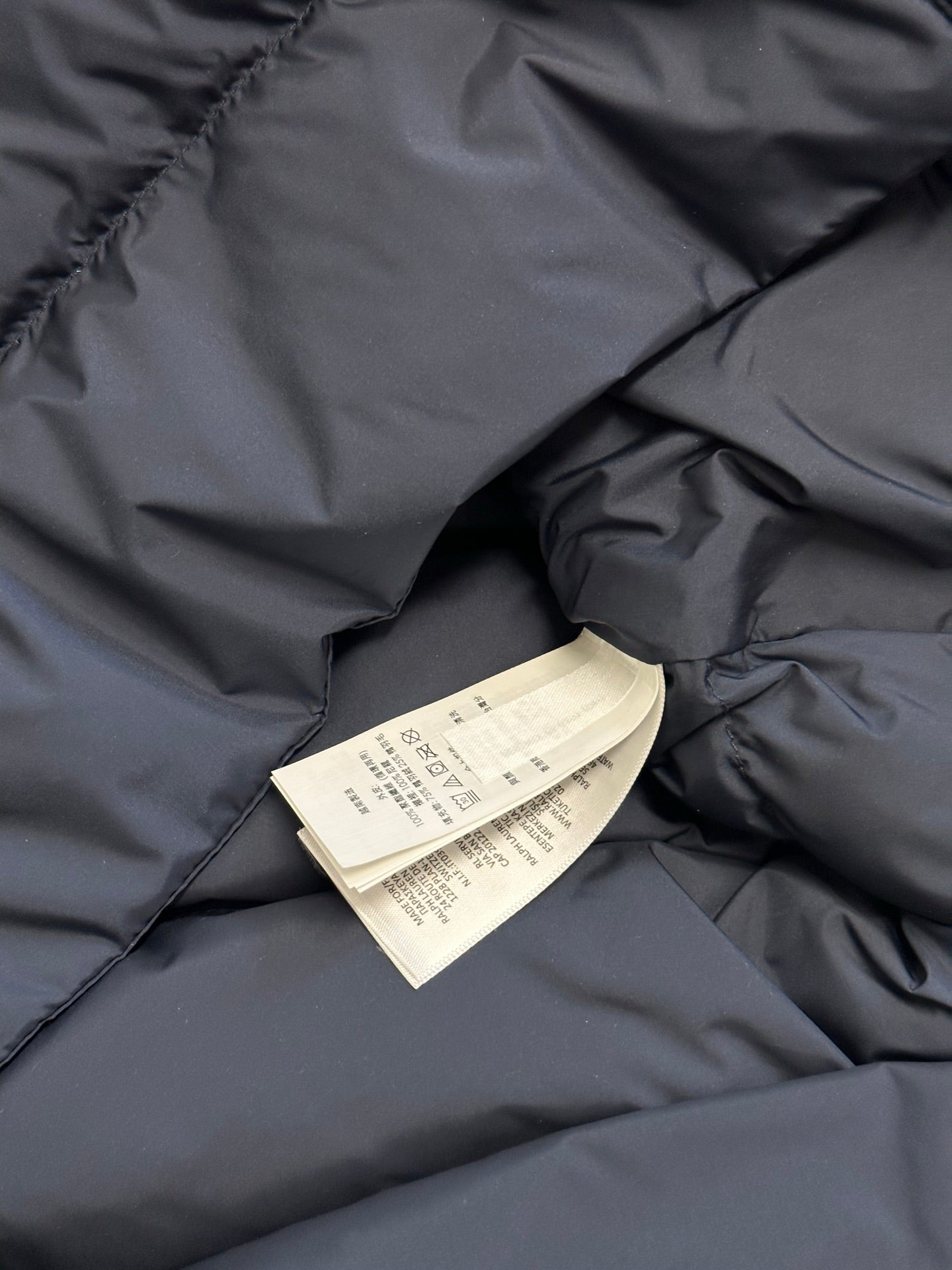 Ralph Lauren puffer jacket lining with care label tag, navy blue