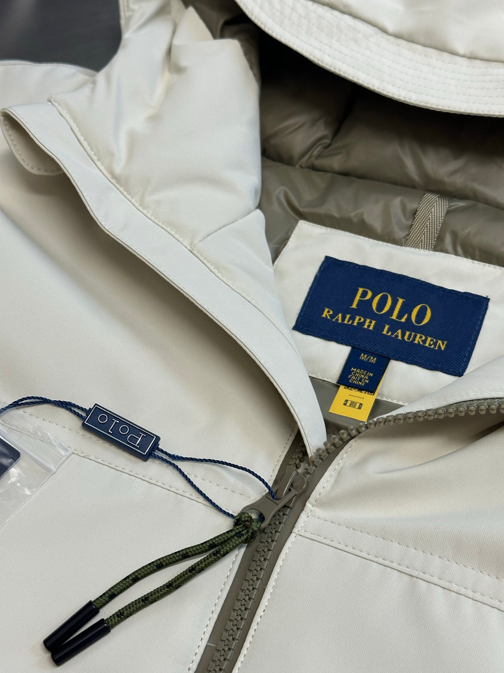 Light beige hooded jacket with Polo Ralph Lauren label and drawstring cords