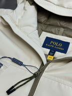 Light beige hooded jacket with Polo Ralph Lauren label and drawstring cords