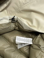 Light beige jacket interior with hood opening and hanging care tags