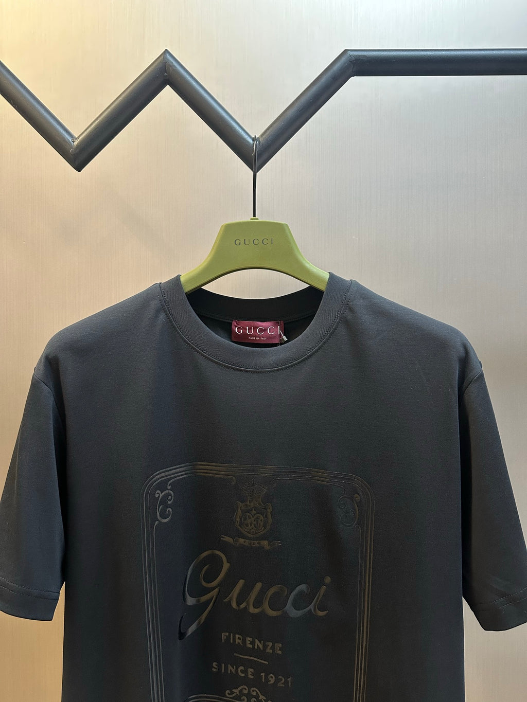 Dark navy T-shirt with round neck and metallic Gucci crest logo graphic